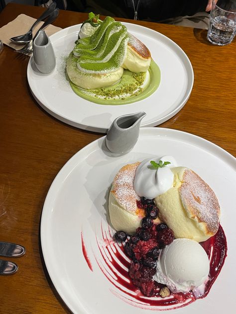 Two orders of soufflé pancakes. Bottom is a stack of the mixed berries soufflé pancakes. Top is a stack of the matcha soufflé pancakes. Both topped with whipped cream and come with a side of ice cream and extra berry sauce and matcha sauce, respectively. Souffle Pancakes Aesthetic, Korea Pancake, South Korea Aesthetic, Souffle Pancake, Soufflé Pancakes, Gangnam Seoul, Pancake Cafe, Korea Aesthetic, Souffle Pancakes