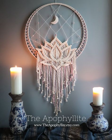 This beautiful wall hanging design features a lotus blossom design made using macrame rope-knotting techniques, framed by a cotton-covered a double hoop. The moon pendant is carved from shell and measures 7cm in height. The main beads are pink-zebra jasper with a frosted (matte) finish in light shades of pink, grey, and white, accessorised with small clear glass and sliver coloured metal beads.  This mandala has been handwoven using high quality Makrame Wall Art, Macromae For Beginners Diy, Moon Macrame Wall Hangings, Diy Macrame Gift Ideas, Macrame And Beads, Macrame With Shells, Unique Macrame Ideas, Macrame Mandala Tutorial, White Macrame Wall Hanging