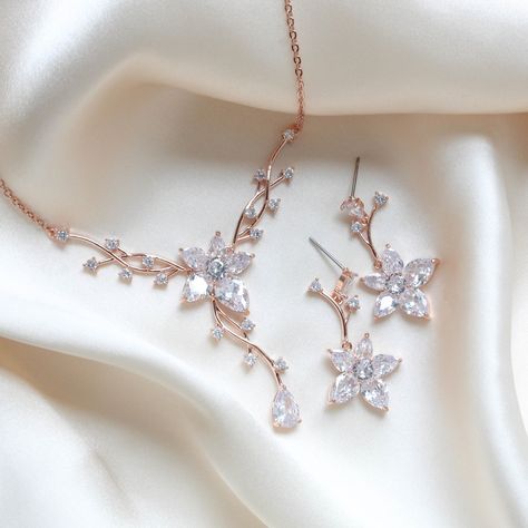 Dainty and elegant Rose gold Bridal jewelry set. Created in a lovely vine floral design that sparkles with Cubic zirconia stones - Necklace measures 16 inches and extends to 18 inches- Earrings dangle 1-3/8"- Rose gold finish- Premium cubic zirconia stones - Nickel free- Available in rose gold, yellow gold and rhodium finish. PLEASE ALLOW APPROX 10 BUSINESS DAYS FOR COMPLETION BEFORE SHIPPING. FOR MATCHING PIECES SIMPLY TYPE "LILY" IN THE SEARCH BAR Simple Rose Gold Jewelry, Rose Gold Jewellery Aesthetic, Wedding Jewelry Rose Gold, Floral Necklace Jewelry, Rose Gold Bridal Jewelry Set, Rose Gold Necklace Set, Rose Gold Necklaces, Wedding Jewelry Gold, Rose Gold Jewelry Set