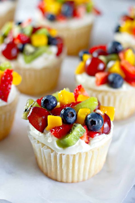 Fruit Pizza Cupcakes are a perfect treat for any occasion! A homemade white cupcake topped with fresh whipped cream cheese frosting and piled high with all your favorite fruits and berries--a really refreshing dessert for any season. #fruit #cupcakes #Cake #fruitpizza #fruitsalad #dessert #dessertrecipes #creamcheese #birthdaycake Fruit Shaped Desserts, Cupcakes Decorated With Fruit, Fresh Fruit Cupcakes, Fruit Cupcake Ideas, Cupcake With Fruit On Top, Fruit Decorated Cupcakes, Fruit Topped Cupcakes, Fruit Themed Cupcakes, Cupcakes With Fruit On Top