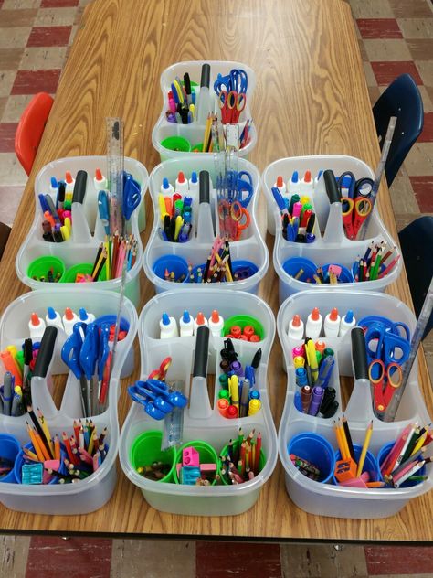 Just made art bins for every art table. Bins are shower caddies from walmart $2.67. The plastic cups came from dollar tree store in a set of 6. It took 2 hours to replace everything, and refill glue bottles but definitely worth the organization for all of my junior high students. Art Table Classroom, Art Table Organization Kids, Table Trash Bins Classroom, Class Supplies Organization, Kindergarten Classroom Tables, Table Bins For Classroom, Desk Caddy Classroom, Table Supply Organization Classroom, Art Classroom Storage Ideas