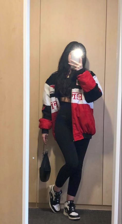 girl with dark long hair wearing black leggings, black top, ferrari racer jacket, black shoulder bag and jordan’s in a mirror pic F1 Racer Jacket, Outfits With Racing Jacket, F1 Jacket Outfit For Women, Ferrari F1 Outfit, F1 Race Day Outfits, Racing Style Outfits, F1 Inspired Outfits, Ferrari Jacket Aesthetic, Race Track Outfit Women