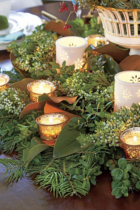 Glowing Centerpiece | Scatter votives of different sizes throughout fresh greenery on the table for a simple centerpiece that doesn’t have to be watered. A small vase is also filled with loose greenery for additional interest. #holiday #decor #southernliving Greenery Centerpiece, Dining Room Centerpiece, Natural Christmas Decor, Christmas Dining Room, Holiday Greenery, Christmas Table Centerpieces, Natural Christmas, Christmas Bedroom, Christmas Greenery