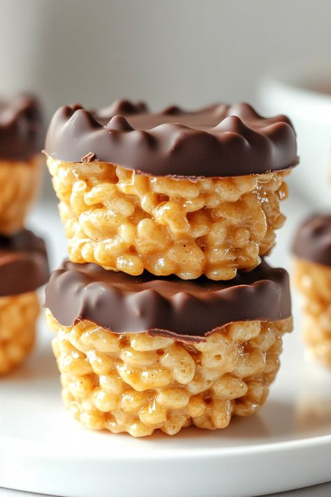 If you're a fan of peanut butter cups or the classic duo of chocolate and peanut butter, you're in for a treat with these Chocolate Peanut Butter Rice Krispie Cups! They're the ideal indulgence to satisfy your sweet cravings. Get ready to enjoy crafting a snack that's as enjoyable to make as it is to Rice Krispie Treats With Peanut Butter And Chocolate, Rice Krispie With Peanut Butter, Cocoa Crispy Treats Rice Krispies, Reeses Puffs Rice Crispy Treats, Rice Krispie Peanut Butter Treats, Peanut Butter Chocolate Rice Krispies, Rice Krispie Cookies Recipes, Sweet Treats Easy To Make Quick, Desert Cups Ideas