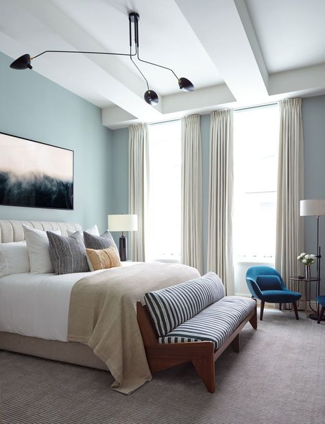 “We struck a balance between making the space feel masculine, while still giving it the ability to appeal to a woman,” notes Sanders of the master bedroom. The walls are bathed in Pale Powder by Farrow & Ball; a bed from Consort cozies up to a bench from Sabin. Over the bed hangs a dreamy art piece by Brian Merriam. Serge Mouille Ceiling Lamp, Bachelor Pad Decor, Modern Ceiling Light Fixtures, Interior Minimalista, Eclectic Bedroom, Bachelor Pad, Bedroom Paint Colors, Design Del Prodotto, Bedroom Paint