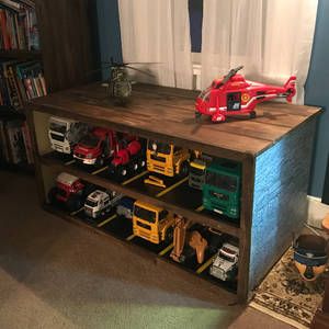 Playroom Truck Storage, Big Truck Storage Kids Rooms, Bruder Toys Storage, Kids Truck Storage, Bruder Truck Storage, Toy Truck Organization, Large Toy Truck Storage Ideas, Toy Truck Storage Ideas, Toy Truck Storage