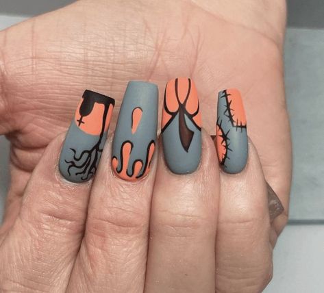 These coffin-shaped nails feature a Halloween design with a matte grey base and orange accents. The nails have spooky elements such as dripping blood, a creepy tree, spider webs, and stitched patterns, creating a chilling and eye-catching look. Matte Halloween Nails, Nail Designs Orange, Creepy Tree, Dripping Blood, Coffin Shape Nails, Spider Webs, Halloween Nail Designs, Orange Accents, Halloween Nail