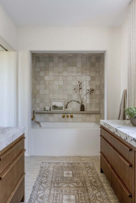 a neutral organic bathroom with a built in tub in a niche clad with Zellige tiles, rich stained vanities and white stone countertops White Stone Countertops, Built In Tub, Zellige Tile Bathroom, Wabi Sabi Bathroom, Attic Shower, Mirror And Sconces, Organic Bathroom, Timber Vanity, Georgia House