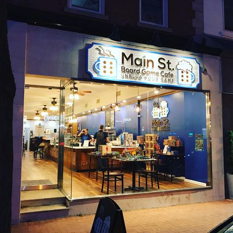 Main Street Board Game Cafe Arcade Coffee Shop, Gaming Coffee Shop, Board Game Cafe Ideas, Boardgame Cafe Design, Board Game Shop, Game Cafe Design, Gaming Cafe Design, Boardgames Cafe, Cafe Design Ideas