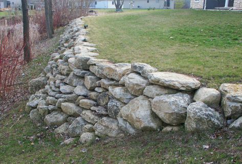 Glacial limestone boulder wall Stone Pitching Retaining Wall, Field Stone Retaining Wall, Fieldstone Retaining Wall Ideas, Riprap Retaining Wall, Fieldstone Retaining Wall, Limestone Retaining Wall, Boulder Wall, Boulder Retaining Wall, Rock Retaining Wall