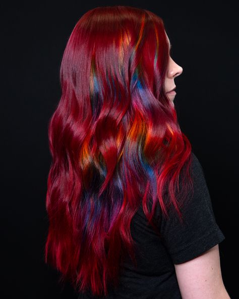 Elevate your hair game with this stunning color trend! Ruby red hair with prism pieces is the perfect blend of deep, rich tones and playful rainbow highlights. The ruby red base provides a luxurious and intense color, while the prism pieces add a unique rainbow effect that catches the light beautifully. Perfect for those who love to experiment with their look and want a hairstyle that's both bold and fun. Vivid Red Hair Color, Vivid Red Hair, Prism Hair, Ruby Red Hair, Rainbow Highlights, Fantasy Hair Color, Unicorn Hair Color, Vivid Hair, Pulp Riot Hair Color