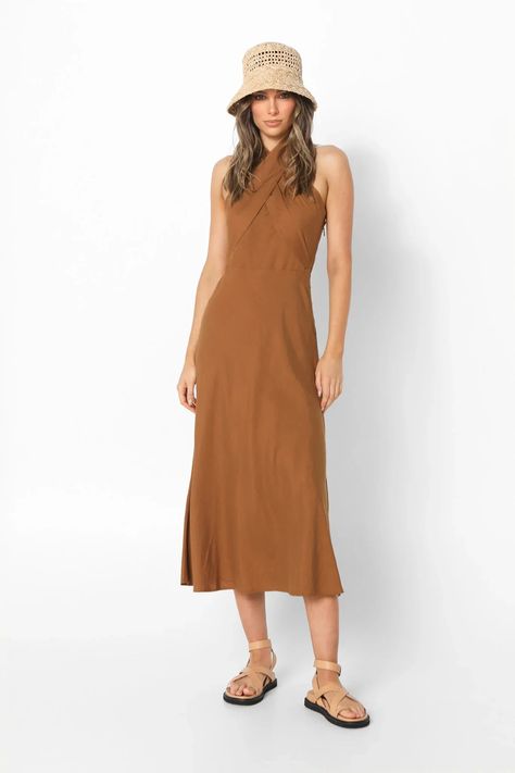 Lost in Lunar Santina Maxi Dress - Effortless Earthy Elegance Indulge in effortless style with the Lost in Lunar Santina Maxi Dress. This breezy brown linen blend dress is crafted from a comfortable 70% cotton and 30% linen fabric, perfect for warm days and balmy nights. Features: Flattering Silhouette: The relaxed loose fit drapes beautifully on all body types, offering all-day comfort and a touch of bohemian flair. Unique Design: The crisscross bust panels add a touch of visual intrigue, while the halter neck tie neckline creates a delicate and adjustable fit. Earthy Chic: The rich brown hue evokes a sense of natural elegance, making this dress perfect for a stroll on the beach, a summer picnic, or a night out. Earthy Chic, Linen Blend Dress, Polo Shirt Dress, Youth Clothing, Baby Outerwear, Casual Dress Shoes, Romper Dress, Polo Dress, Dress Romper