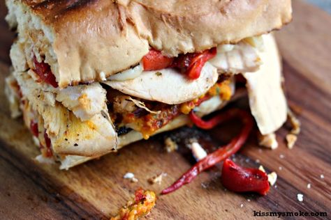 Grilled Smoked Chicken Sandwich with Roasted Red Peppers, Mozzarella, and Red and Yellow Pepper Pesto | kissmysmoke.com | This sandwich is so over the top good. I smoked a chicken, then sliced it up, then turned it into a grilled chicken sandwich layered with roasted red peppers, mozzarella and fire roasted yellow and red pepper pesto! Smoked Chicken Sandwich, Pepper Pesto, Pepper Sandwich, Potato Bites, Steak Bites, Yellow Pepper, Fire Roasted Tomatoes, Smoked Chicken, Kiss My