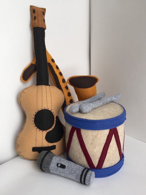 These adorable handmade instruments will have your little one grooving along with all your favorite tunes in no time. Perfect for pretend play with Baby Instruments, Music Nursery, Instruments Music, Toy Instruments, Music Toys, Diy Nursery, Felt Book, Music Instrument, Fabric Toys