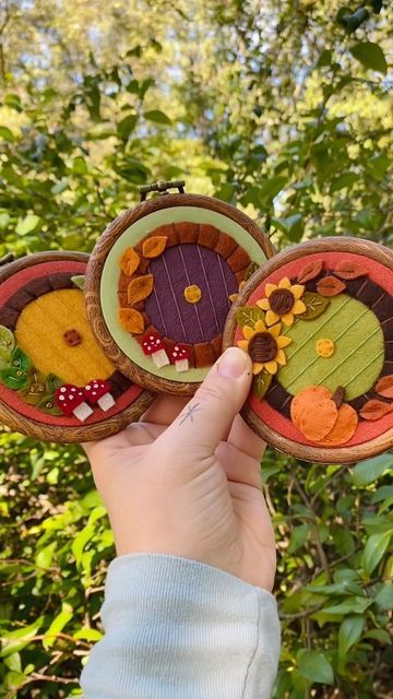 Brianna on Instagram: "Oh to be in the Shire in the fall. 🍂 Three mini Hobbit door hoops will be in the Halloween update on Sept 24 at noon EST! . . . #lotr #tolkien #hobbit #hobbitdoor #feltart #modernembroidery #fiberart #embroideryart #handstitched #stitchersofinstagram #dmcembroidery #michiganartist #bordados #benziedesign" Felt Hobbit House, Lord Of The Rings Felt Pattern, Hobbit Day Ideas, Lord Of The Rings Felt Ornaments, Hobbit Door Embroidery, Hobbit Door Ornament, Felt Embroidery Hoop, Lotr Embroidery Pattern, Diy Hobbit Door