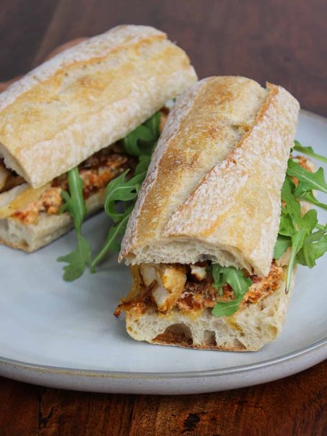 Make this fresh and healthy chicken and goat cheese sandwich with sun-dried tomatoes, caramelized onions, and arugula for a delicious lunch. Chicken Sandwich With Arugula, Goat Cheese Chicken Sandwich, Sandwich With Goat Cheese, Chicken Arugula Sandwich, Chicken And Cheese Sandwich, Goat Cheese Sandwich Recipes, Chicken And Goat Cheese Recipe, Fall Sandwich, Chicken And Goat Cheese