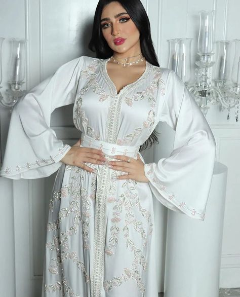 A nice moroccan kaftan embroidered with high quality of materials,handcrafted,designed by Kaftan. -This white kaftan comes with a belt -It has a fabulous embroidory work - Silk golden aqads - Silk golden sfifa - Golden handmade embroidory with cristals - very nice for henna party. -wedding day Why choosing our store? -Fast reply -An original design for each kaftan from Kaftan, it can't be found anywhere. White Caftan, White Gown Dress, Moroccan Kaftan Dress, Princess Ball Gowns Wedding Dress, Moroccan Bride, White Kaftan, Wedding Dress Outfit, White Bridesmaid, Moroccan Dress