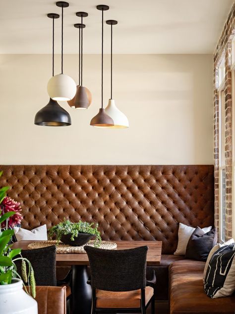 This dining room is the perfect mesh of rustic and modern. The rustic comes through with leather and brick, while a whimsical light source adds in a modern flare! + Leather Bench + Dining Room Design + Modern Light + Brick Wall + Lobby Dining Seating + Rustic Modern Dining Room + Tall Bench Seat | Design by Lori Clarke Design Built In Dining Room Seating, Masculine Dining Room, Banquette Seating In Kitchen, Dining Room Bench Seating, Banquet Seating, Kitchen Banquette, Booth Seating, Dining Room Seating, Banquette Seating