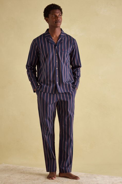 Designed for downtime, this set of men's pyjamas will have him kicking back in style and comfort. They're crafted from soft 100% cotton and feature a classic pinstripe design for a truly gentrified look. The button down shirt has a lapel collar, a single patch pocket to the chest and piped trims, while the matching bottoms have an elasticated waist with drawstring ties and a branded tab to the front. Side pockets complete the set and add to its laid-back appeal. 100% cotton. Pyjama set. Button d Men’s Loungewear, Panto Costumes, Pyjamas Men, Mens Pyjamas, Pajamas Men, Pinstriping Designs, Cute Pajama Sets, Sequin Outfit, Striped Pyjamas