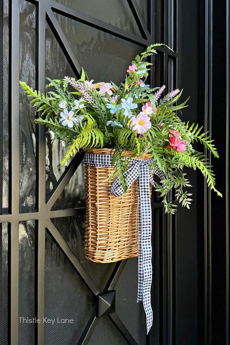 Spring Flowers Door Basket - See how to brighten up your front door with a simple wicker door basket full of pretty spring flowers. Spring Door Decoration. How To Make A Spring Door Basket With Flowers. Easy Spring Craft Project. Moss Wreath Diy, Front Door Baskets, Basket With Flowers, Spring Door Decoration, Wreath Alternative, Door Basket, Expensive Decor, Creative Wreaths, Flowers Easy