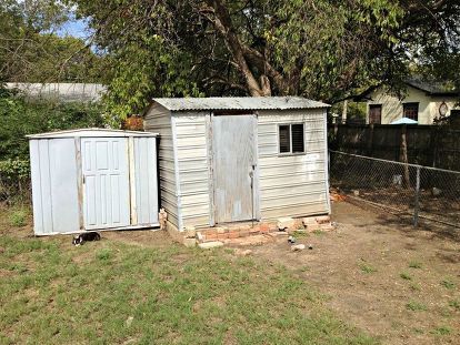 Just in time for Spring! We transformed our super ugly sheds with very little money with scrap pallet, fence, and miscellaneous lumber. The door on the large shed was our old back door (we replaced with a glass door from Habitat ReStore). We also used paint we were given to paint the blue shed. Even the flower box brackets were in someone's trash. Our "splurge" was the fun orange paint for the doors! Visit our site for a few in-between steps: http://upcycledugly.com/yard-make-over/… Shed Redo, Garden 101, Blue Shed, Shed Makeover, Pallet Projects Garden, Habitat Restore, Coffee Shop Photography, Dream Bedroom Inspiration, Pallet Fence