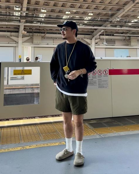 man wearing sweatshirt, shorts, and birkenstock clogs Birkenstock Clogs Outfit Men, Men Birkenstock Outfit, Mens Birkenstocks Outfit, Birkenstock Boston Outfit Men, Birkenstock Boston Clog Outfit, Birkenstock Outfit Men, Potato Shoes, Boston Clogs Outfit, Clog Outfits