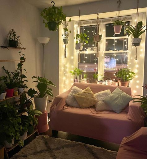 plants fairy lights pink sofa night time cute cozy Cozy Room Decor Fairy Lights, Pink Room Plants, Cozy Fairy Lights Living Room, Pink Forest Bedroom, Room Ideas Low Light, Plants Fairy Lights, Pink Plant Bedroom Aesthetic, Pink Plant Room Aesthetic, Pink Living Room With Plants