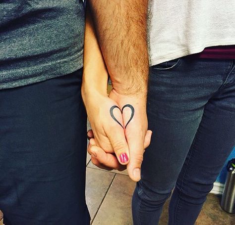 Half Heart Couple Tattoo, He's And Hers Tattoos, Couple Tattoos That Connect, Matching Heart Tattoos Couple, Half Heart Tattoo Couples, Heart Tattoo For Couples, Couples Heart Tattoos, Holding Hands Tattoo Couple, Half A Heart Tattoo