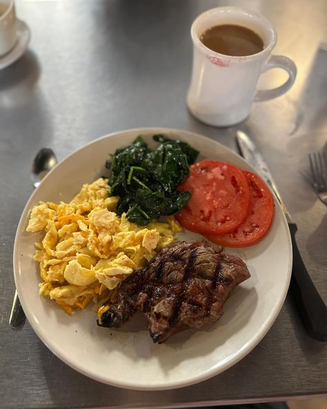 The breakfast of champions. Steak and eggs with a 6oz ribeye, scrambled eggs with 🥚 🧀 , fresh tomatoes 🍅, sautéed spinach 🥬 and a side of coffee ☕️ And the best seat of the house as a solo traveler - right at the kitchen pass. #foodie #foodporn #foodblogger #foodphotography #foodislife #memorablefood #chicagogirlinasouthernworld #foodiesofinstagram #wilmington #thebasicsilm #breakfast #steakandeggs Healthy Steak And Eggs Breakfast, Spinach Eggs Recipe, Egg And Steak Breakfast, Steak And Eggs Recipe, Steak Breakfast Ideas, American Breakfast Ideas, Steak And Eggs Breakfast, Meat And Vegetable Diet, Beef And Eggs