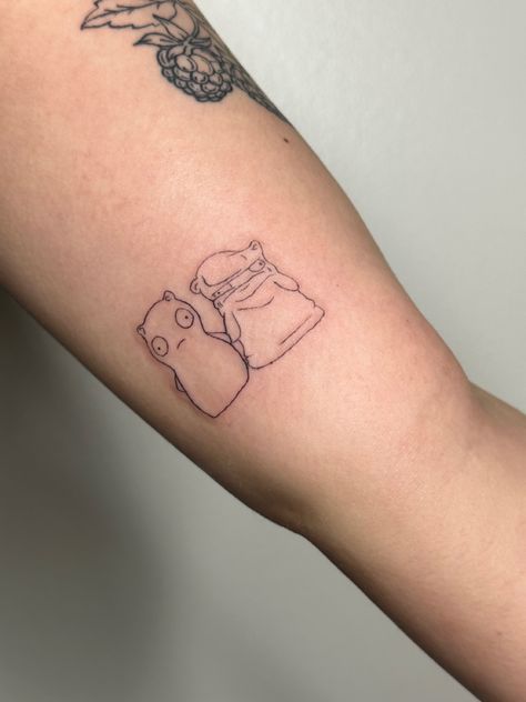 Fine lined tattoo on the inner arm, it features kuchi kopi which is a night light toy from bob’s burgers holding hands with the melted version of itself. Bobs Burgers Tattoo Kuchi Kopi, Bowling For Soup Tattoo, Matching Bobs Burgers Tattoos, Bobs Burgers Matching Tattoos, Simple Bobs Burgers Tattoo, Bobs Burger Tattoo Ideas, Kuchi Kopi Tattoo, Small Bobs Burgers Tattoo, Bobs Burgers Tattoo Ideas