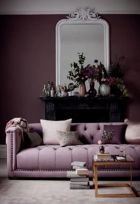 Picture of a gorgeous living room with a deep purple accent wall, a lilac sofa, a glass coffee table, a black fireplace and beautiful blooms on the mantel Rose Sofa, Purple Accent Wall, Purple Accent Walls, Purple Living Room, Purple House, Collection Decor, Purple Sofa, Purple Interior, Purple Rooms