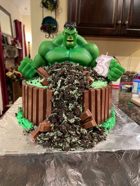 I made this Hulk Smash Birthday cake using the Hulk bank character from Amazon,  chocolate cake mix, vanilla Marshmallow icing with greens food colors, crushed mint Oreos and Kit Kat’s. Birthday Cake For My Son, The Hulk Party Ideas, Hulk Cakes For Boys, Hulk Cake Ideas Easy, Hulk Bday Cake, Hulk 2nd Birthday Party, Incredible Hulk Birthday Cake, Easy Hulk Cake, Simple Hulk Cake