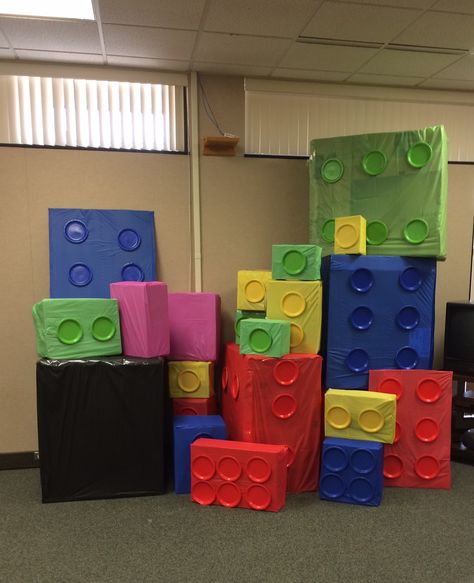 Giant LEGO blocks to make a fort. Made out of boxes, tablecloths, and paper plates, along with lots of tape and hot glue! #lego #blocks #library #legos Lego Theme Parade Float, Diy Giant Lego Blocks, Giant Lego Blocks, Lego Nativity, Kids Parade Floats, Lego Vbs, Lego Classroom Theme, Sunday School Themes, Building Campaign