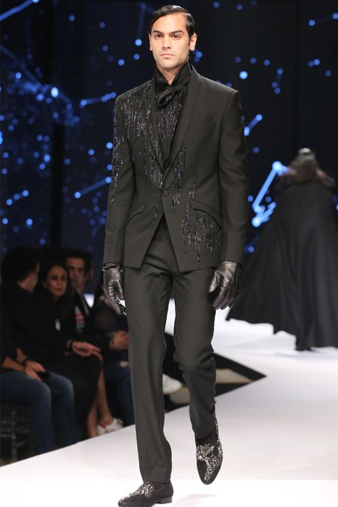 "High-Octane Glamour;  this classic black tuxedo is engineered with delicate glass bugle bead embroidery that exude a cosmic influence. It is punctuated with a slim shawl collar. The creation is paired with black straight trousers. Temper this look with our star rain shirt and tie. Finish with a pair of leather oxfords and sleek pushed back hair. #GauravGupta#menswear# 	 	 	 	 	" Black Sparkly Suits Men, Embroidery Tuxedo Men, Pushed Back Hair, Black Straight Trousers, Man Fashion Style, Mens Evening Wear, Classic Black Tuxedo, Party Dress Ideas, Black Tuxedo Suit