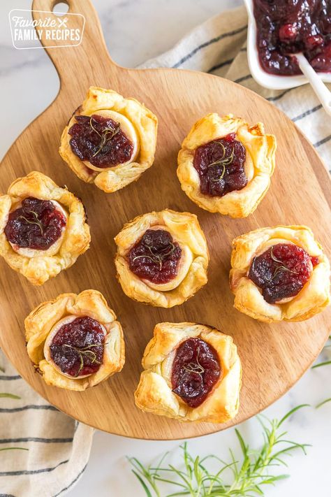 These Cranberry Brie Bites are the perfect holiday appetizer with melty, creamy Brie cheese, tart cranberry sauce, and flaky puff pastry. #cranberrybriebites #holidayappetizers #christmasappetizers #thanksgivingappetizers #briebites Lite Dinners, Brie Bites Puff Pastry, Baked Brie Puff Pastry, Cranberry Desserts, Cloves Recipes, Recipes Using Puff Pastry, Cranberry Appetizer, Cranberry Brie Bites, Creamy Brie