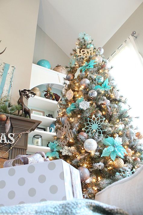 Copper, silver and grays really make the turquoise pop on this snowy Christmas Tree! Turquoise Christmas Tree, Aqua Christmas, Teal Christmas, Turquoise Christmas, Snowy Christmas Tree, Blue Christmas Decor, Blue Christmas Tree, Christmas Tree Ideas, Gold Christmas Tree