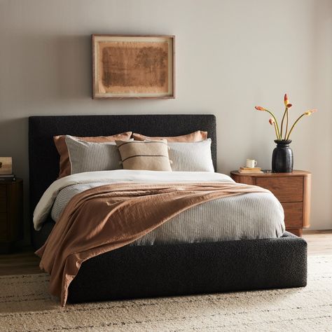 Modern, clean shaping meets inflated comfort with this padded, upholstered bed frame in a textural boucle-like pattern.Product Overview Available Colors: Lisbon Charcoal Lisbon Cream Dimensions: Queen: 73"W x 92.25"D x 48.5"H King: 89"W x 92.25"D x 48.5"H Materials: 81% Pl, 19% Pc, Solid Parawood Performance Fabric: Yes Distance Between Slats: 2.75" Weight: 188.38 lb Black And Oak Bedroom Ideas, Modern Guest Room Ideas, Charcoal Bed Frame Bedroom Ideas, Bedroom With Black Headboard, Black Upholstered Bed Decor Ideas, Black Guest Room, Dark Headboard Bedroom Decor, Cozy Bedroom Black, Black Bed Frame Decor