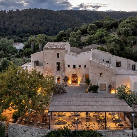 A roughly-hewn stone trough and a traditional mill for pressing olive oil were repurposed as decorative features inside this farmhouse-turned-hotel, set against the backdrop of Mallorca's Serra de Tramuntana mountain range. Lodge Hotel, Small Luxury Hotels, Old Farmhouse, Balearic Islands, The Ranch, Places Around The World, World Heritage Sites, Best Hotels, Boutique Hotel