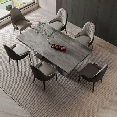 The elegant extendable table with a length adjustable from 78.74 to 110.24 inches, and a width of 39.37 inches, offering ample space for gatherings of any size. The tabletop is crafted from high-quality faux marble, giving you the stunning look of real marble with added durability. The sturdy steel legs provide both stability and a modern aesthetic that complements any dining room decor. Accompanying the table are eight cushioned dining chairs, upholstered in premium faux leather. These chairs o Grey Upholstered Dining Chairs, Marble Dining Table Set, Faux Marble Dining Table, Sintered Stone Dining Table, Grey Dining Tables, Stone Table Top, Faux Leather Dining Chairs, Stone Dining Table, Table Extensible