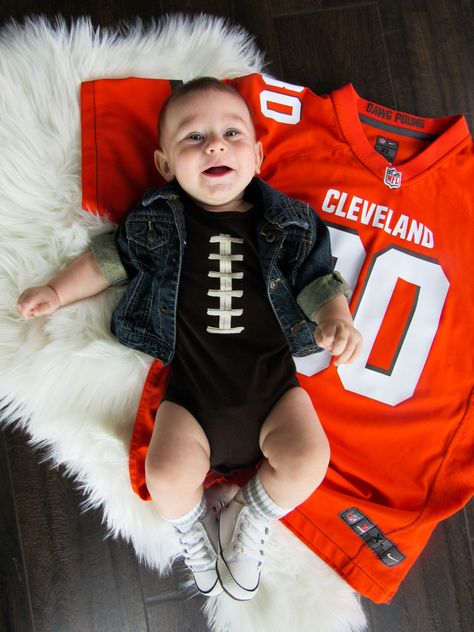 Baby Football Browns photoshoot with Oshkosh jean jacket, Childrens place onesie, and Converse shoes Football 6 Month Photoshoot, Halfway To One Football Photoshoot, One Year Old Football Photoshoot, Baby Football Pictures, Baby Football Photoshoot, Football Baby Photoshoot, Newborn Football Photoshoot, Newborn Football Photography, Football Themed Newborn Pictures