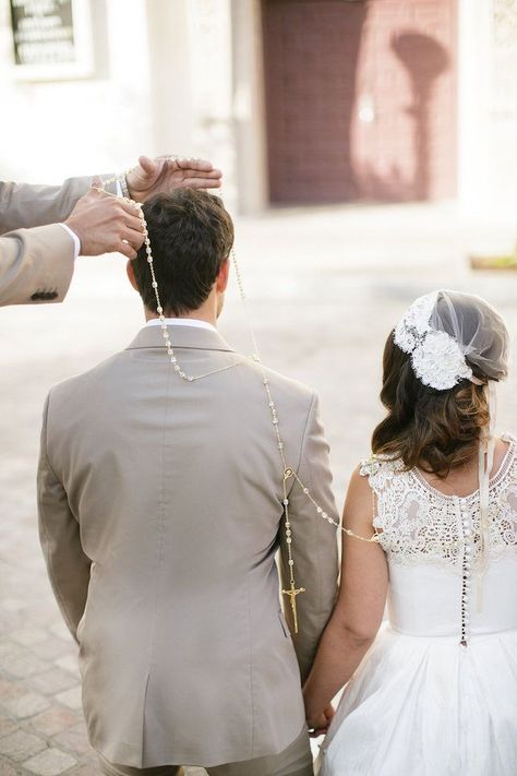 “As part of the ceremony to symbolize unity, a large loop of rosary beads is placed in a figure eight shape around the necks of the couple after they have exchanged their vows. The specially appointed ‘padrinos’ are in charge of lassoing the couple together. The lasso is then gifted to the bride as a souvenir of her taking the groom’s hand in marriage & symbolizes their commitment to each other.” Mexican Wedding Lasso, Lasso Ceremony, Mexican Wedding Traditions, Wedding Rosary, Wedding Lasso, Wedding Ceremony Ideas, Spanish Wedding, Unity Ceremony, Boda Mexicana