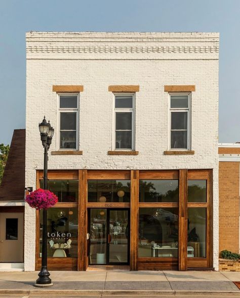 It's a perfect day to visit our beautiful shop! Did you know our space was designed using the sun as inspiration?🌞 We were lucky enough to work with @shelterdesigns to bring our vision to life. Token even won 1st place at the Midwest Home Design Awards gala for Retail Interior Design!✨ City Store Fronts, Quaint Shops Store Fronts, Store Door Design Shop Fronts, Commercial Retail Architecture, Retail Store Exterior Design, Furniture Store Exterior, Cute Shop Exterior, Painted Brick Store Fronts, Small Business Building Exterior