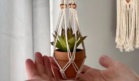 Learn how to make your own Mini Macrame Plant Hanger with beads in this step by step tutorial + video! This pattern is perfect to use as an air plant hanger, car succulent hanger, to adorn your office, or wherever you need a little boho decor. A tiny macrame plant hanger is a great beginner DIY macrame project. If you need a quick DIY gift or 5-minute craft project, this is a great option. #macrametutorial Macrame Plant Hanger For Car, How To Make Mini Macrame Plant Hanger, Mini Plant Hanger Macrame Diy, Mini Macrame Air Plant Hanger Diy, Diy Mini Plant Hanger, Macrame Rearview Mirror Hanger Diy, Mini Macrame Plant Hanger Pattern, Tiny Macrame Plant Hanger Diy, Mini Macrame Plant Hanger Diy