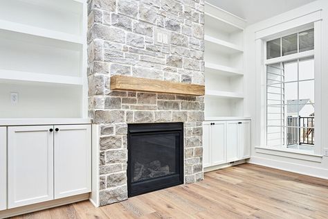 How to Whitewash a Stone Fireplace for an Easy DIY Makeover — The Spruce Painted Fireplace Stone, Whitewash Stone Fireplace, White Wash Fireplace, White Stone Fireplaces, Stone Fireplace Makeover, How To Whitewash, Painted Fireplace, Built In Lockers, Fireplace Stone