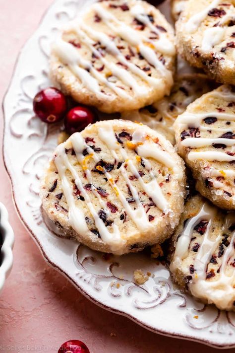 These slice-and-bake style cranberry orange icebox cookies deliver big flavor from surprisingly simple ingredients. They're filled with chewy dried cranberries and fragrant orange zest. Drizzle on an easy 2-ingredient orange glaze for the finishing touch. Recipe on sallysbakingaddiction.com Cranberry Orange Shortbread Cookies, Cranberry Orange Cookies, Icebox Cookies, Orange Cookies, Easy Christmas Cookie Recipes, Sally's Baking, Orange Glaze, White Chocolate Cookies, Cranberry Cookies