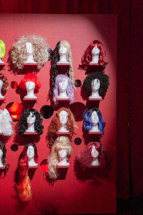 Wig Wall Design, Colorful, Strangely Beautiful, Extravagant, Red, Wig Doors, Mannequins, Spotlight, Event, New York, Decor, Diva, Experiential, Grab And Go Costumes, Activation, Duggal Greenhouse Drag Room Ideas, Wig Stand Wall, Wig Stands Ideas, Wig Heads Decoration, Wig Display Wall, Wig Closet Storage, Event Selfie Wall, Wig Walls, Maximalist Hair Salon Decor