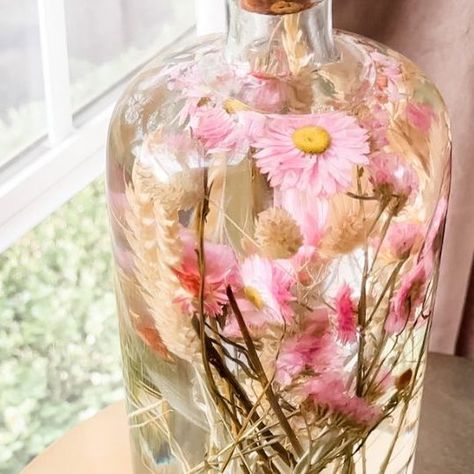 Janine Graff on Instagram: "Herbarium Jars🌸 Preserve cherished memories and capture the essence of special moments using any jar with a cork or lid, dried, pressed flowers + plants and baby oil! I recently learned about Japanese Herbariums and the art of preserving dried flowers in oil for display. I chose to make a larger herbarium, but you can create all different sized displays using any type of jar or container that you can seal with cork or a lid. Directions- - Cut dried flowers to yo Preserve Flowers In Oil, Baby Oil Flower Jar, Flowers In Baby Oil, Preserving Dried Flowers, Japanese Herbarium, Janine Graff, Swim Banquet, Herbarium Art, Wine Lifestyle