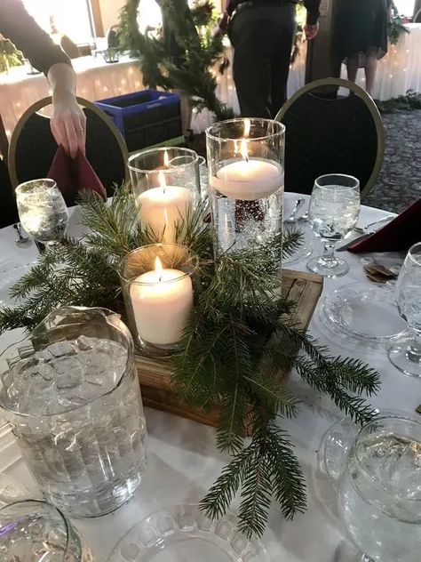 Winter Green Centerpiece Wedding, White Christmas Wedding Centerpieces, Christmas Wedding Centrepiece Ideas, Christmas Wedding Candle Centerpieces, Winter Wedding Table Centerpieces Diy, January Wedding Table Centerpieces, Christmas Banquet Round Table Decorations, Winter Centre Pieces, Understated Wedding Centerpieces