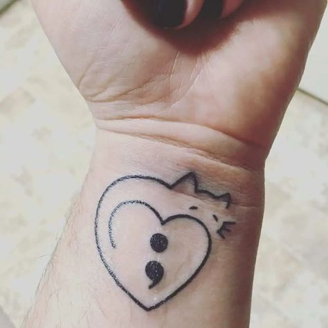 https://thestyleup.com/wp-content/uploads/2020/02/cat-semicolon-tattoo.webp Semicolon Tattoo Meaning, Colon Tattoo, Cat Tattoo Ideas, Army Tattoos, Semi Colon, Semicolon Tattoo, Tattoo Now, Creepy Tattoos, Heart Tattoo Designs