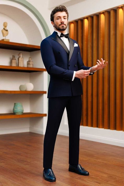 Enjoy the timeless appeal of this 2-piece navy double-breasted tuxedo suit. This suit radiates elegance and guarantees a professional and dapper appearance with its dominating 6-button blazer, peak lapels, and double vents. #tuxedo #navytuxedo #groom #navyslimfittuxedo #elegantstyle #sophisticatedlook #formalattire #refinedluxury #weddingattire Navy Blue Suit Men, Best Wedding Suits For Men, Marriage Suits, Indian Wedding Suits Men, Double Breasted Suit Men, Designer Tuxedo, Indian Wedding Clothes For Men, Best Wedding Suits, Navy Tuxedos